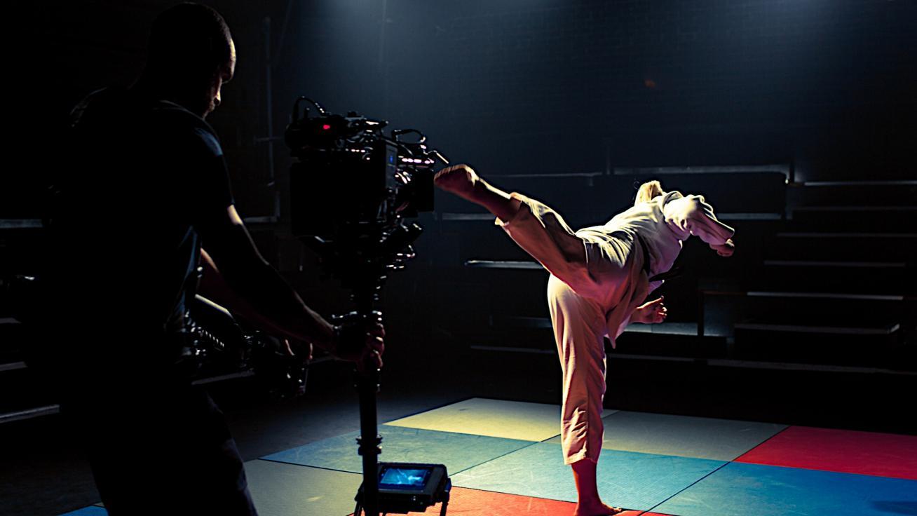 Female martial artist performing a back kick